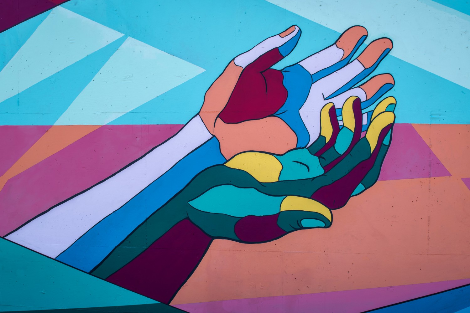 Colorful hands reaching out Photo by Tim Mossholder on Unsplash