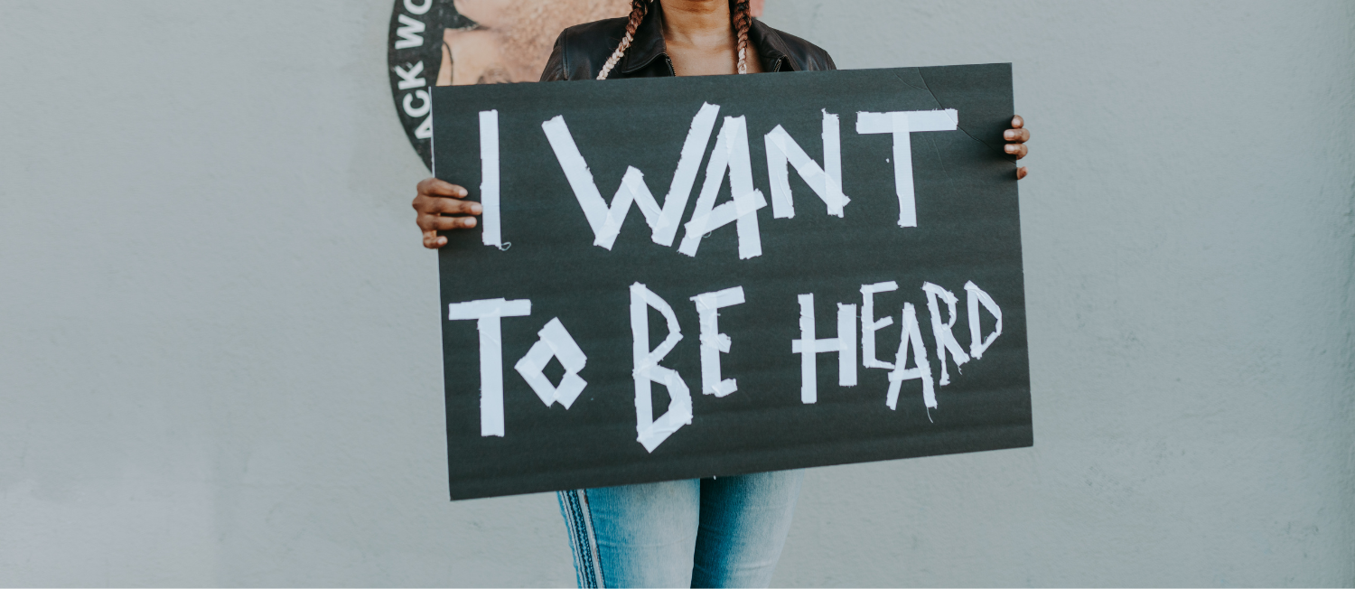 An image of a person holding a sign that reads 