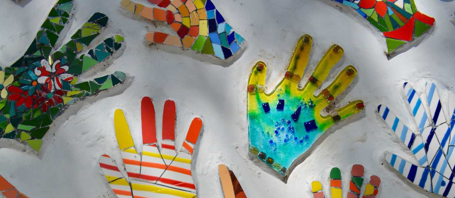 Photo of mosaic handprints on a wall