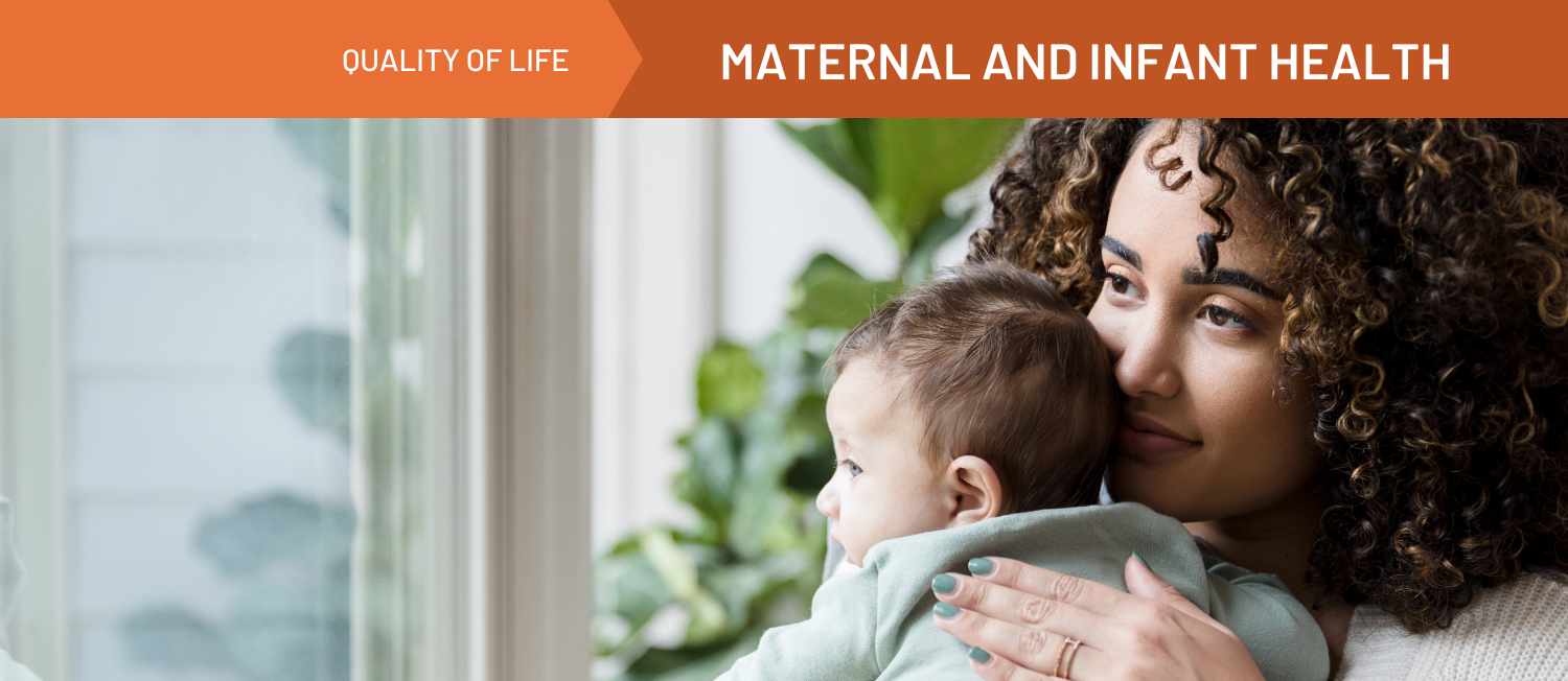 A photo of a person with curly hair holding a baby. An orange banner spanning the top of the image reads 